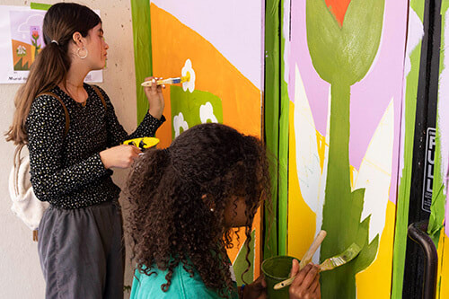 Volunteers work on Shawna Chen's community mural